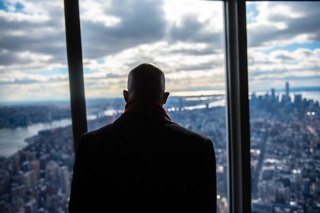 Mayor Eric Adams overlooks Manhattan on the top floor of a high-rise.